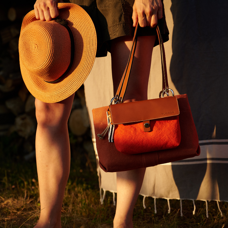 sac de ville modulable en coton brique avec des anses en cuir naturel et sa mobile porte dans un jardin corail